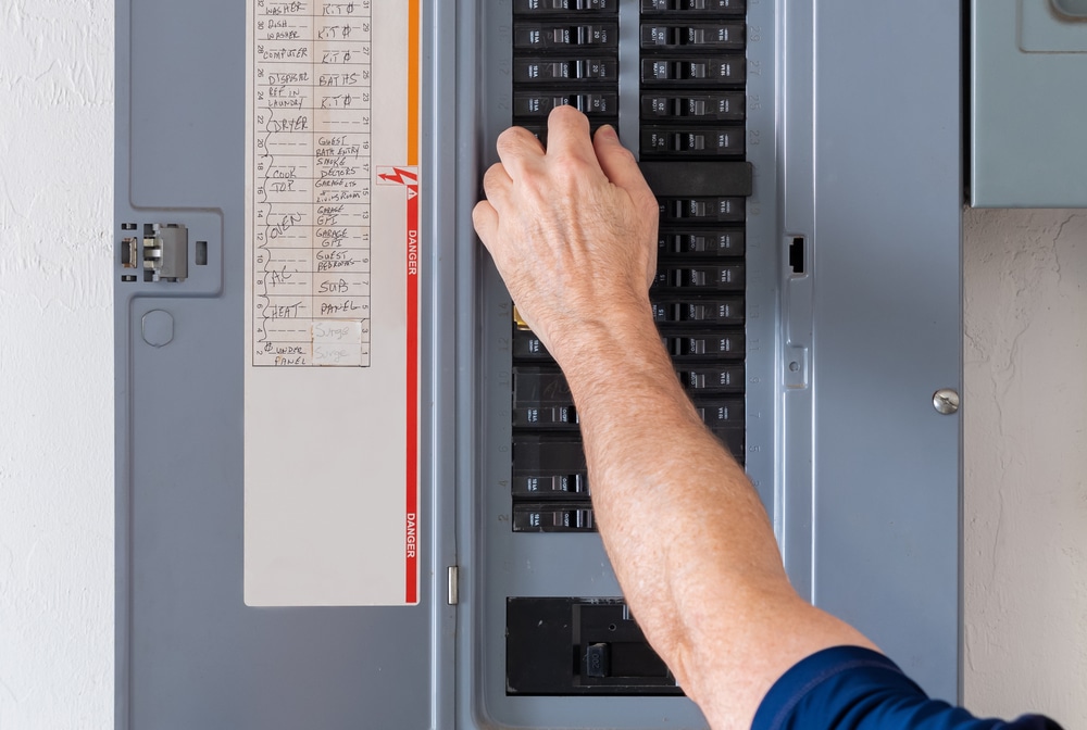 Resetting,Tripped,Breaker,In,Residential,Electricity,Power,Panel.,Male,Electrician