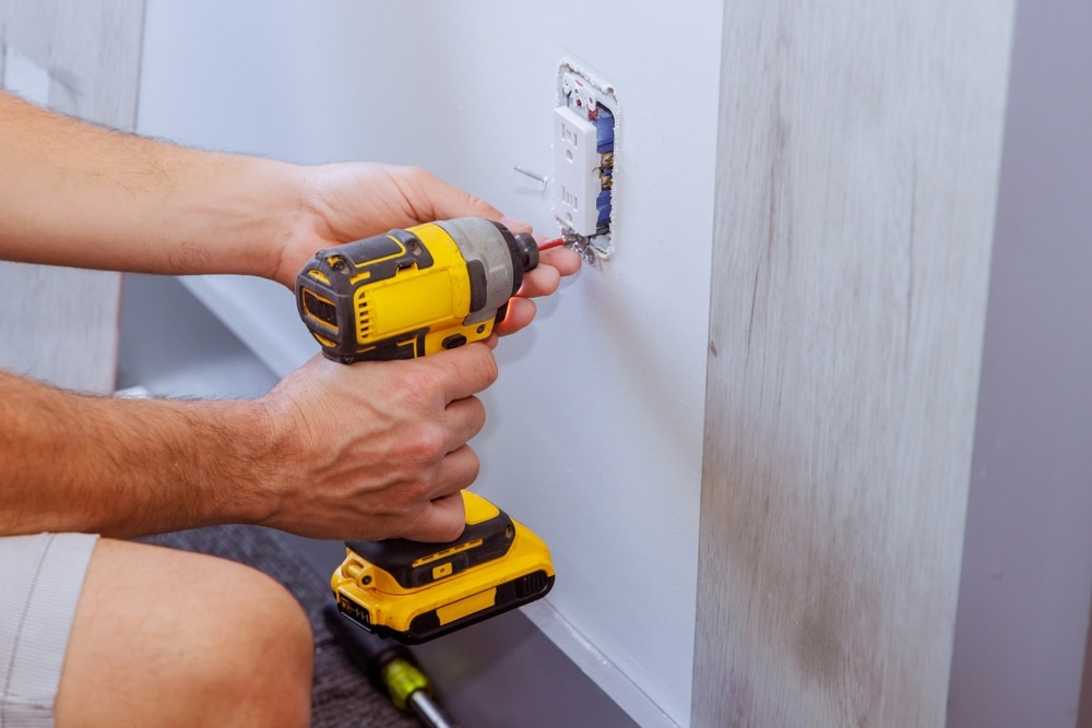 When,Constructing,A,House,,Electrician,Uses,Screwdriver,To,Install,An